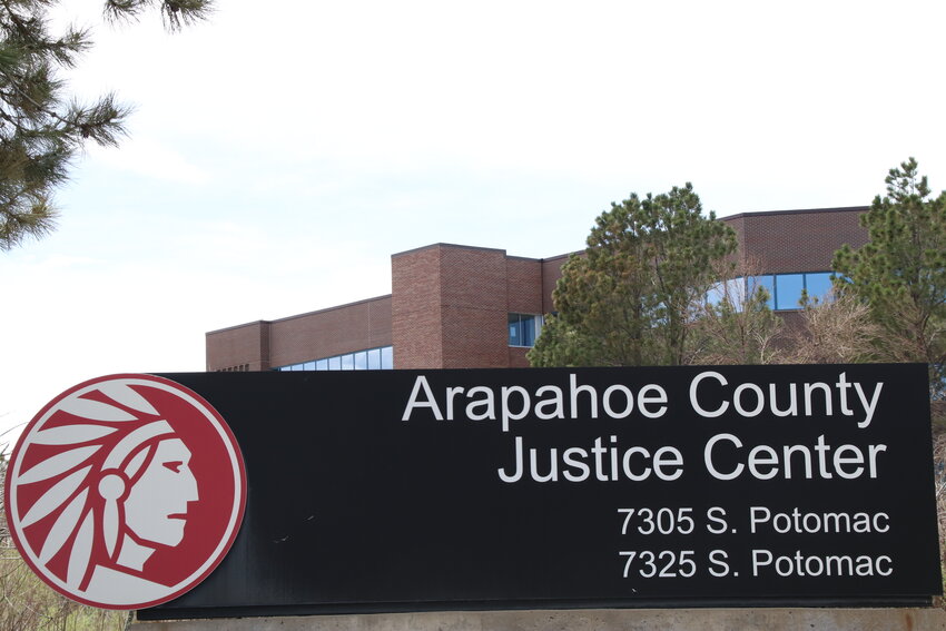 A sign stands outside the Arapahoe County Justice Center in May in Centennial.
